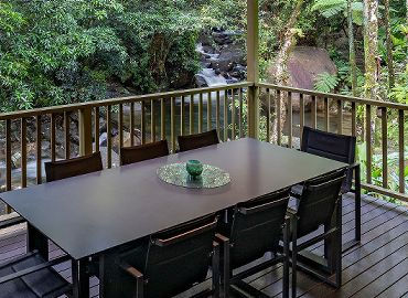 Alfresco veranda deck overlooking the private waterfalls, swimming hole, and lush Daintree Rainforest.