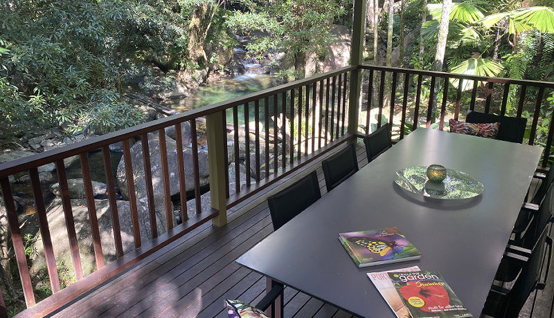 Spacious timber verandah deck overlooking the private freshwater swimming hole and natural waterfalls