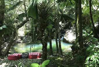 Scenic view looking down toward the private swimming hole and lounge bean bags at our Daintree holiday home.