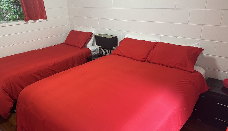 Third guest bedroom configured with a comfortable queen-size bed and a supportive long single bed