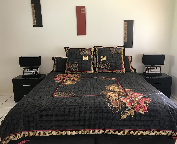 Master bedroom sanctuary styled with a premium king-size Westin Hotel Group bed looking out to tropical gardens