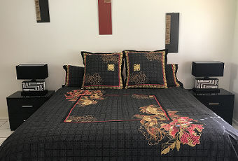 Spacious master bedroom with a comfortable king bed at our Daintree Rainforest accommodation.