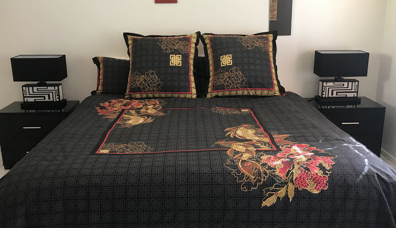 Second guest bedroom featuring a premium king-size Westin Hotel Group bed surrounded by rainforest views